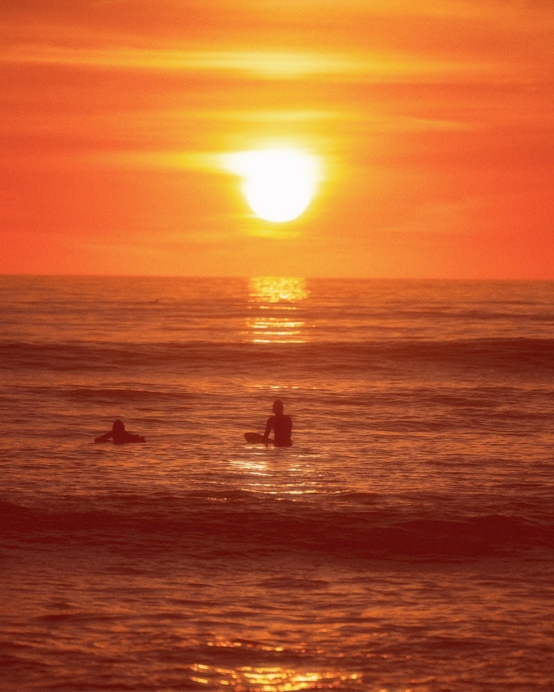 Surfer Watches Sunset